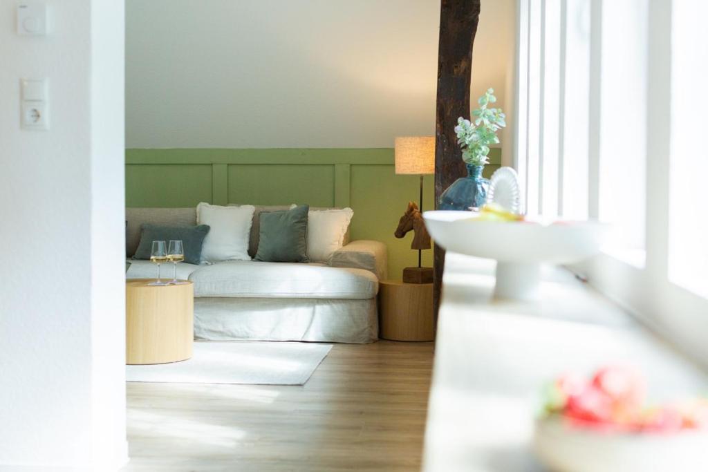 a living room with a couch and a table at Fewo Eickhorst in Menslage