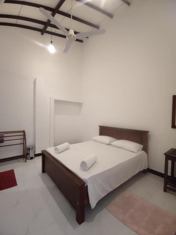 a bedroom with a bed and a ceiling at Chandra Holiday Home Hiriketiya in Dickwella