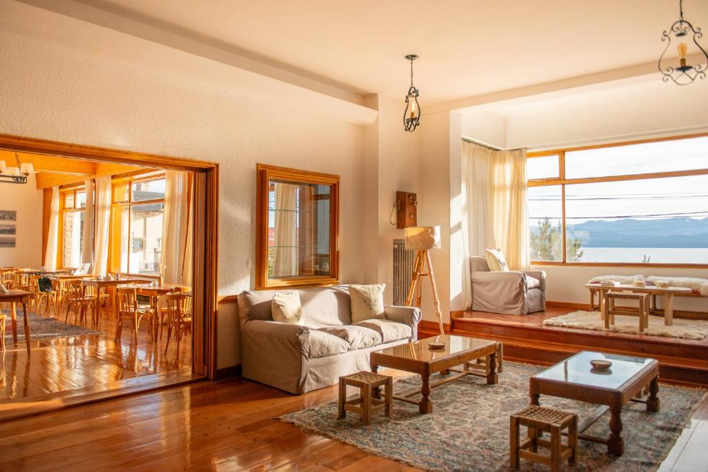 a living room with a couch and a table at Del Lago Sky Hotel in San Carlos de Bariloche