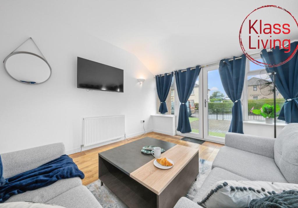 a living room with a couch and a table at Fraser House by Klass Living Rutherglen in Glasgow