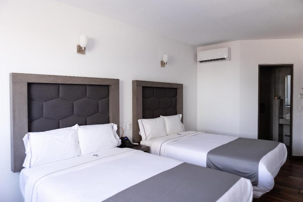 Postel nebo postele na pokoji v ubytování Hotel Bugari Aeropuerto Guadalajara