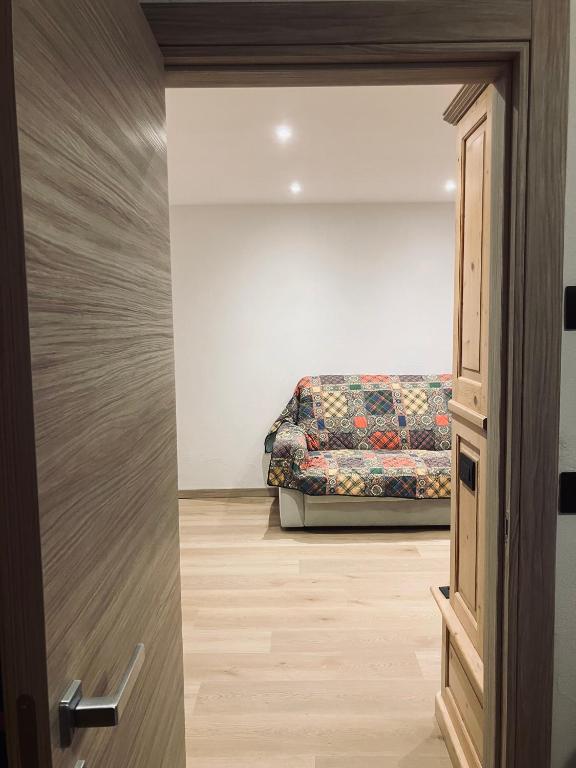 a door leading into a living room with a couch at CERMIS Minisuite in Cavalese