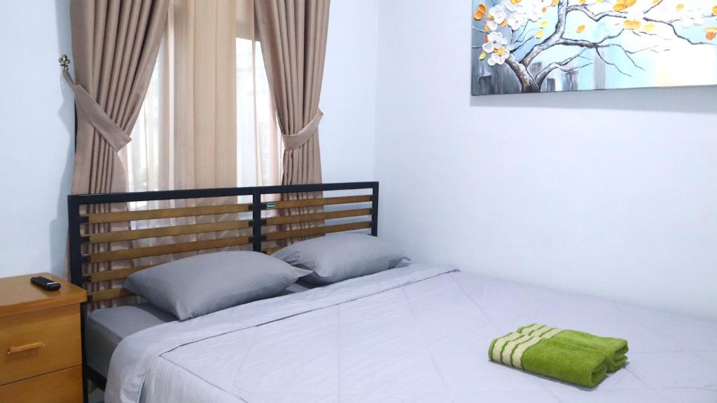 Postel nebo postele na pokoji v ubytování Cataleya Homestay Lagoi Bintan