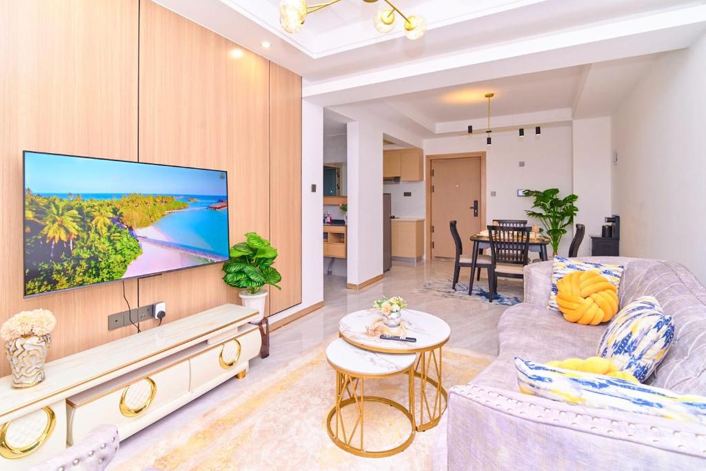 a living room with a large flat screen tv at Leshwa House 1 in Nairobi