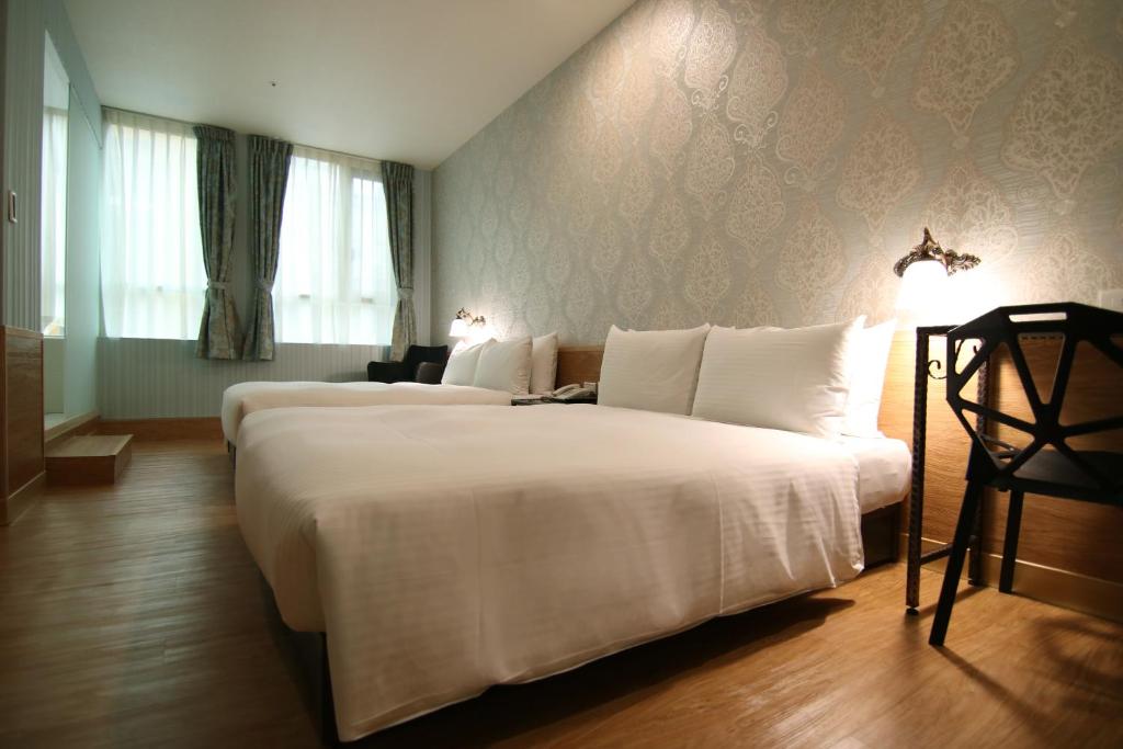 Postel nebo postele na pokoji v ubytování LIHO Hotel Hankou