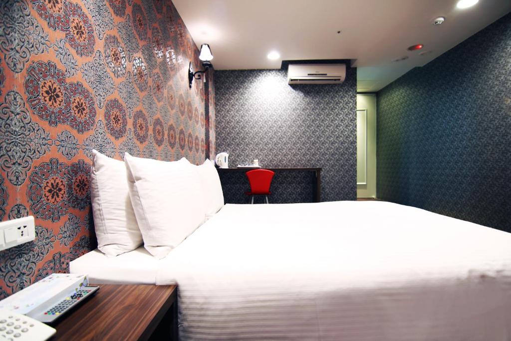 Postel nebo postele na pokoji v ubytování LIHO Hotel Hankou