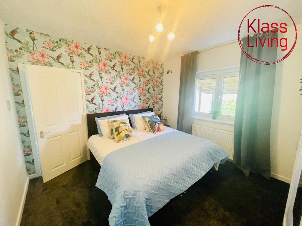 a small bedroom with a bed and a window at Mitchell Apartment by Klass Living Coatbridge in Coatbridge