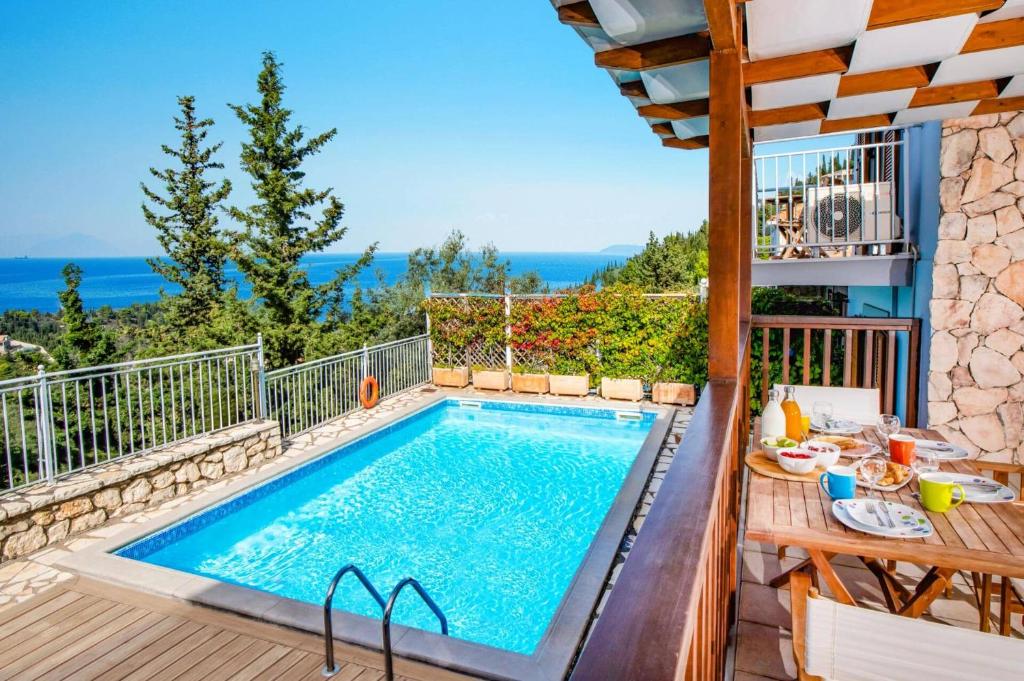 a pool on a balcony with a view of the ocean at Villa Anna Nikitas by Villa Plus in Agios Nikitas