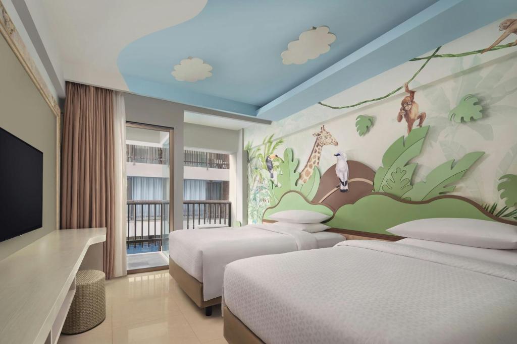 Postel nebo postele na pokoji v ubytování Four Points by Sheraton Bali, Kuta