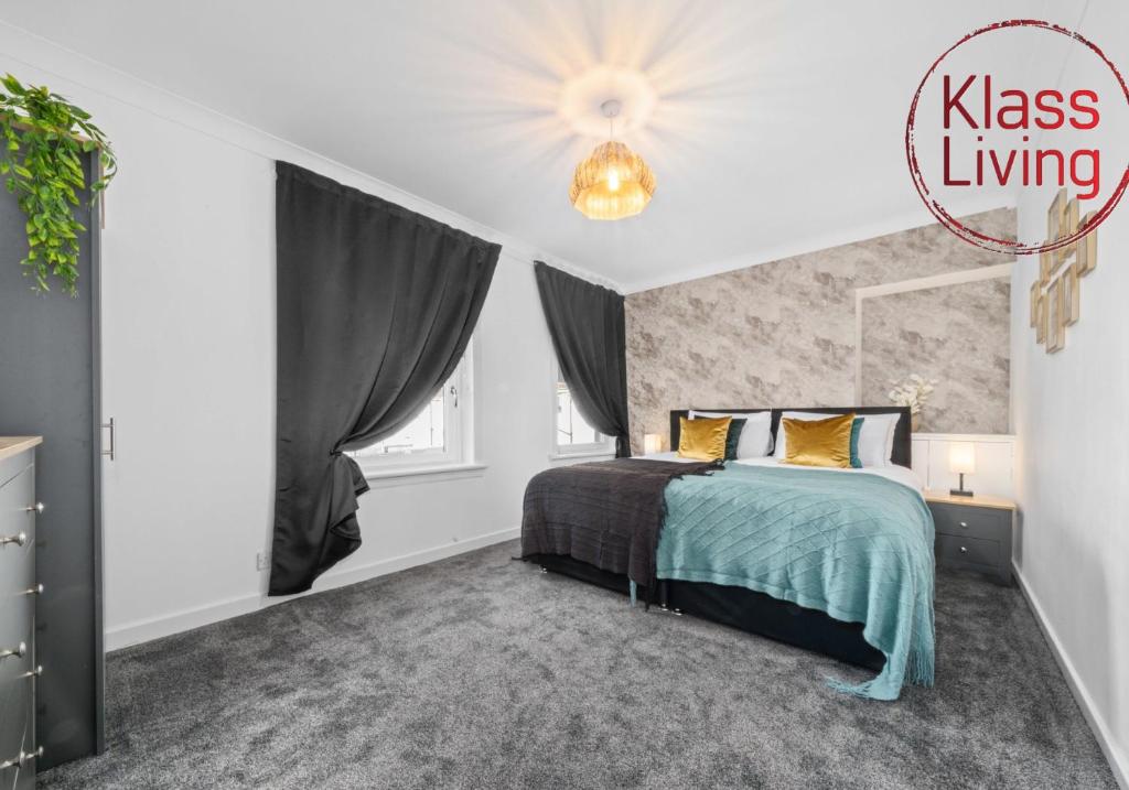 a bedroom with a bed and a chandelier at Orbiston House by Klass Living Bellshill in Bellshill