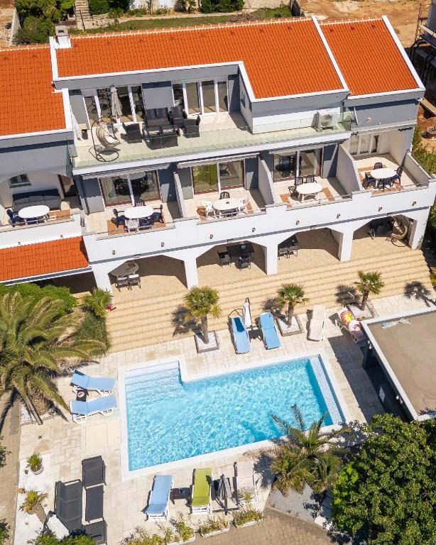 an aerial view of a house with a swimming pool at Peaceful OAZA in Stara Novalja