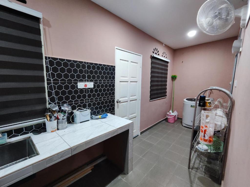 a kitchen with a sink and a counter top at Homestay Temerloh Free Netflix Wi-fi 300MBPS 4 Bedroom 3 Air-cond Water Heater Water Filter in Temerloh