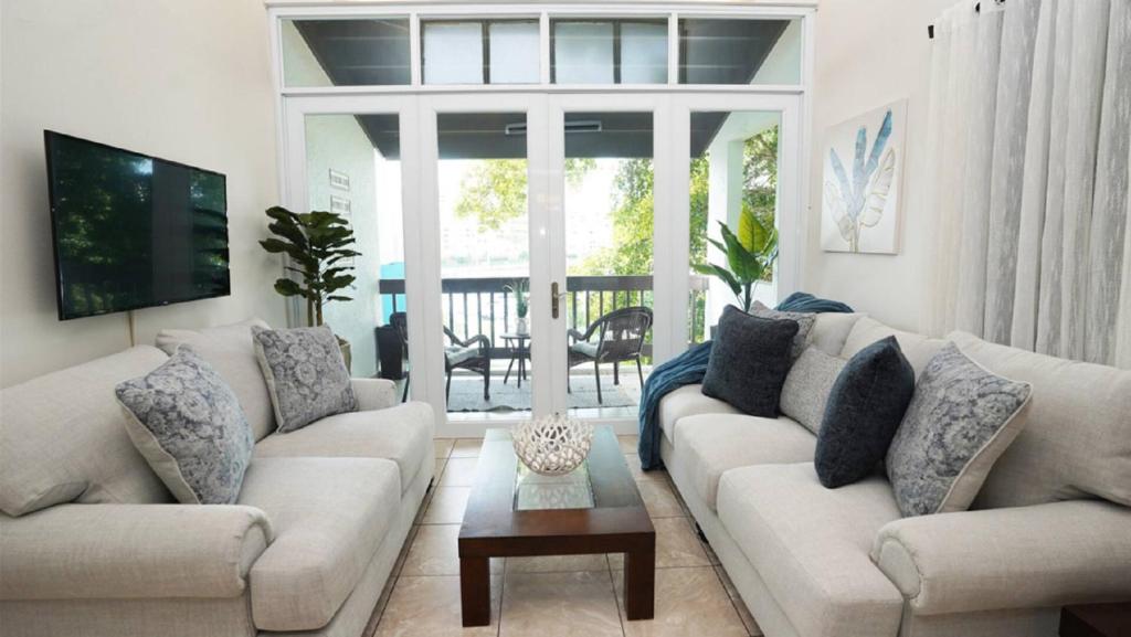 a living room with two couches and a table at Sea Breeze Villa in Fajardo