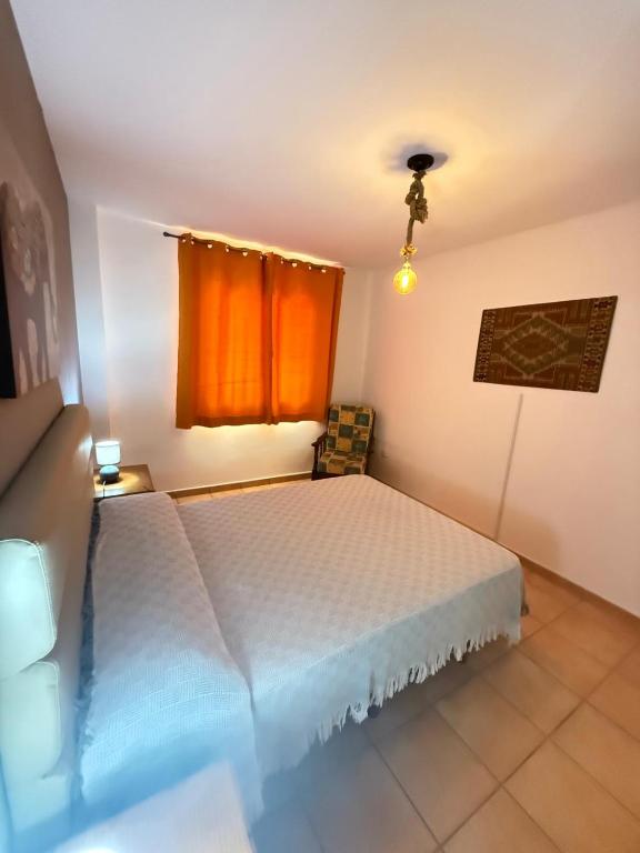 Postel nebo postele na pokoji v ubytování Corralejo Suite