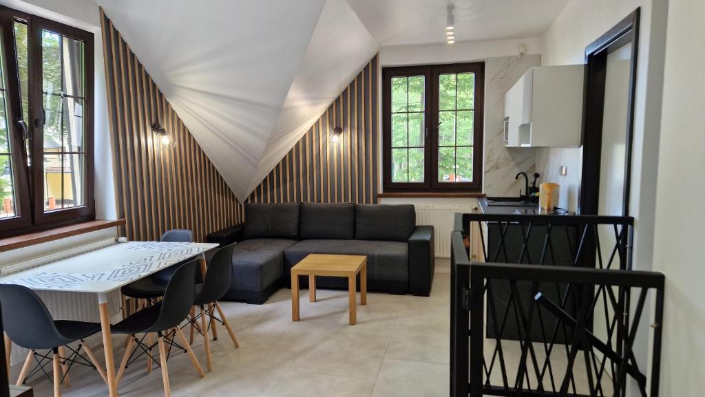 a living room with a couch and a table at Domek Nadmorski przy plaży Ustka in Ustka