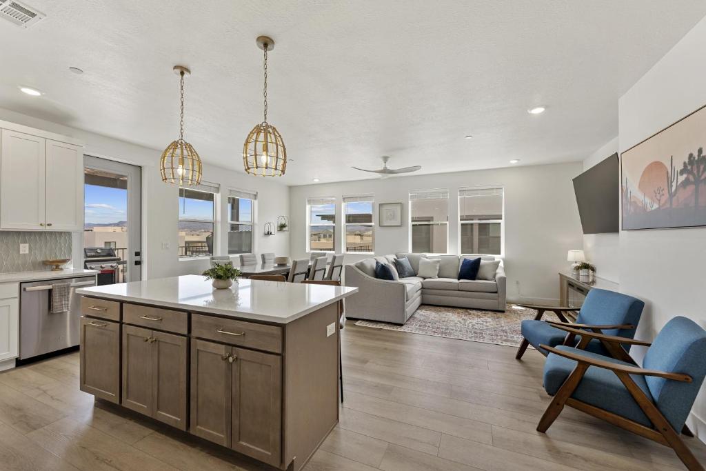 a kitchen and living room with a couch and a table at Periwinkle Sky condo in St. George