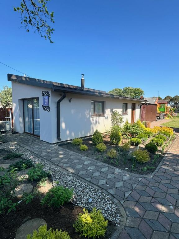 a house with a garden in front of it at Tac Premier in Ventspils