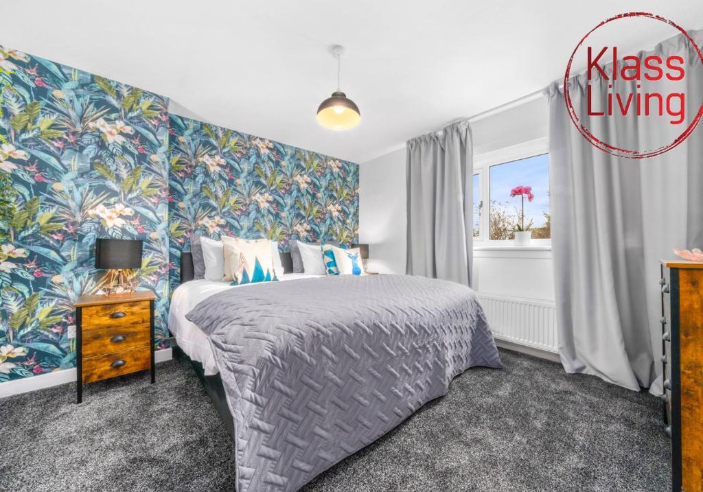 a bedroom with a king sized bed and a window at West End House by Klass Living Bellshill in Bellshill