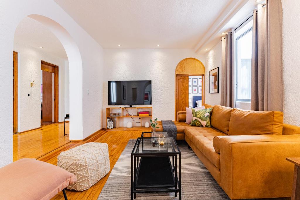 a living room with a couch and a table at Bright and Secure Condo near Chapultepec & Museums in Mexico City