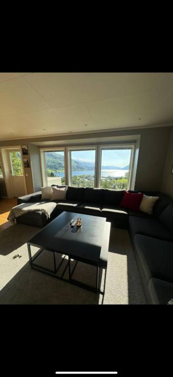 a living room with a couch and a table at Leiligheit i Hornindal in Volda