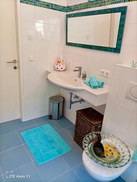 a bathroom with a toilet and a sink at Schwalbennest Velden in Velden am Wörthersee