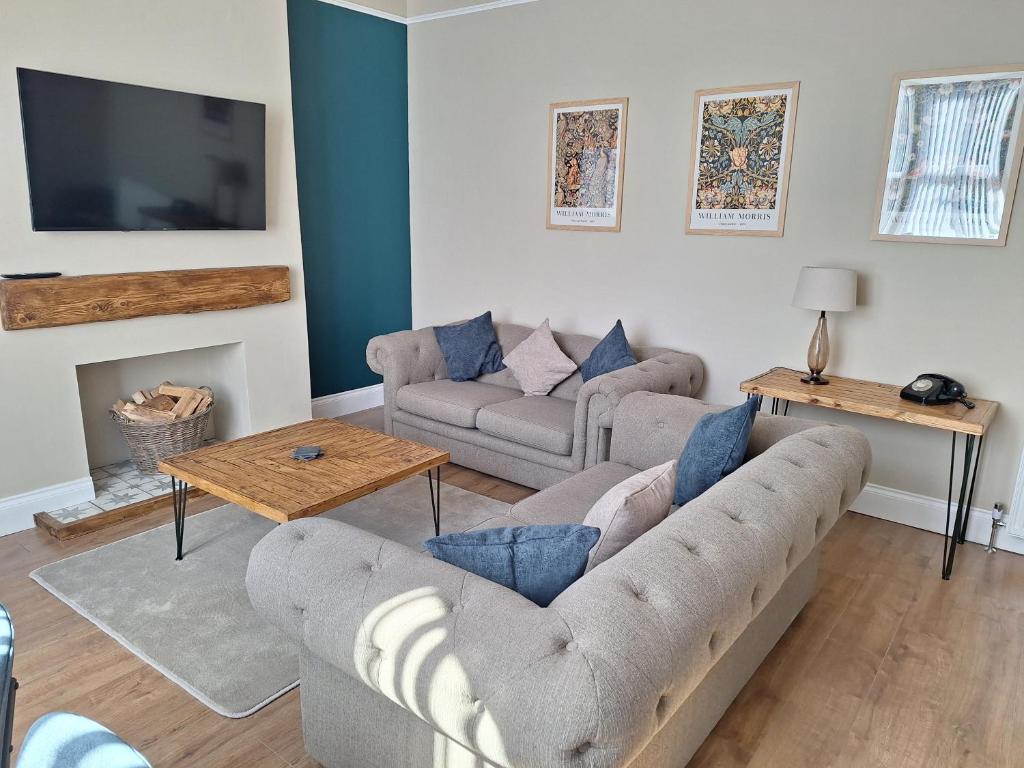 a living room with two couches and a tv at Annie's Place in Saltburn-by-the-Sea