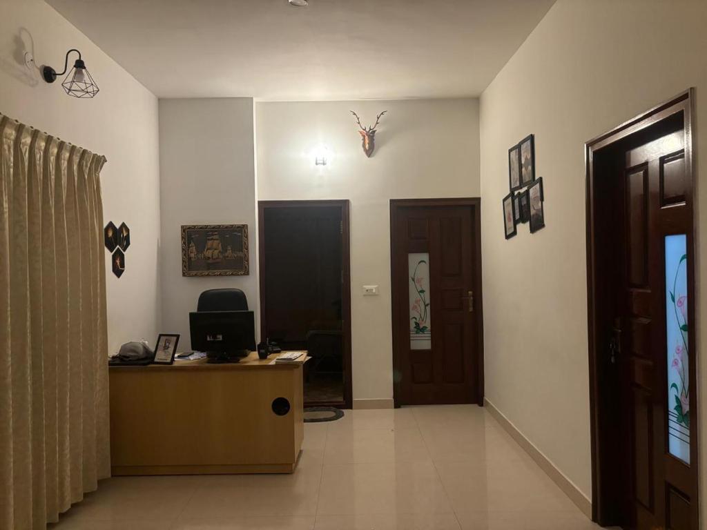 a room with a desk with a computer on it at Sapthagiri Euphoria in Chikmagalūr