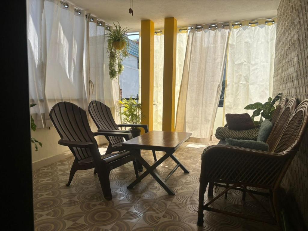 a living room with chairs and a table and a couch at Sapthagiri Euphoria in Chikmagalūr