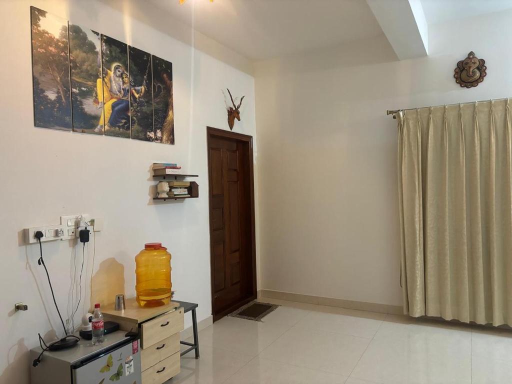 a room with a table and a painting on the wall at Sapthagiri Euphoria in Chikmagalūr