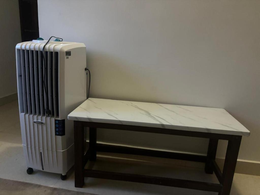 a bench next to a radiator next to a room at Sapthagiri Euphoria in Chikmagalūr