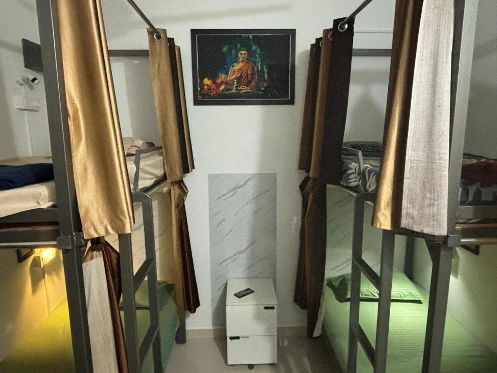 a room with two bunk beds and a painting on the wall at Sapthagiri Euphoria in Chikmagalūr