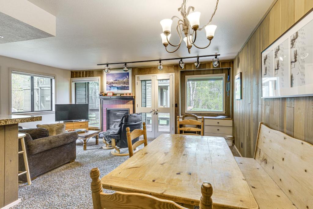 a living room with a wooden table and a couch at Walk to Sun Valley Village Condo with Deck! in Sun Valley