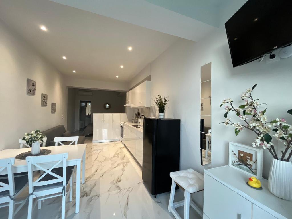 a kitchen and living room with a table and chairs at Aggelikas apartments 2 in Paleokastritsa