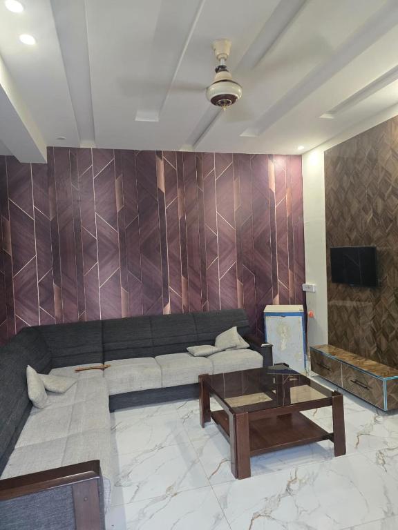 a living room with a couch and a table at Cozy 1 Bed Studio on Canal Rd in Dargai