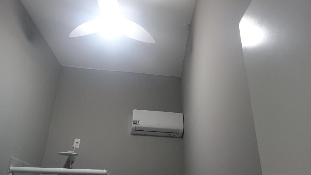 a bathroom with two lights on the ceiling at Hospedagem Cinelândia AP 617 in Rio de Janeiro