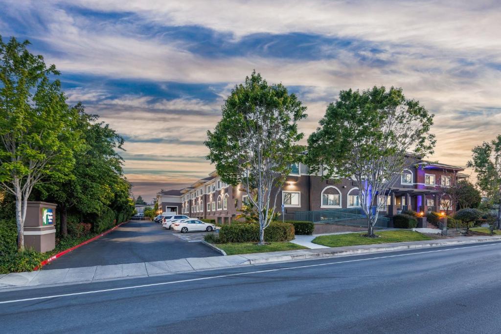 a street in a town with houses and a car at Holiday Inn Express & Suites Mountain View Silicon Valley by IHG in Mountain View