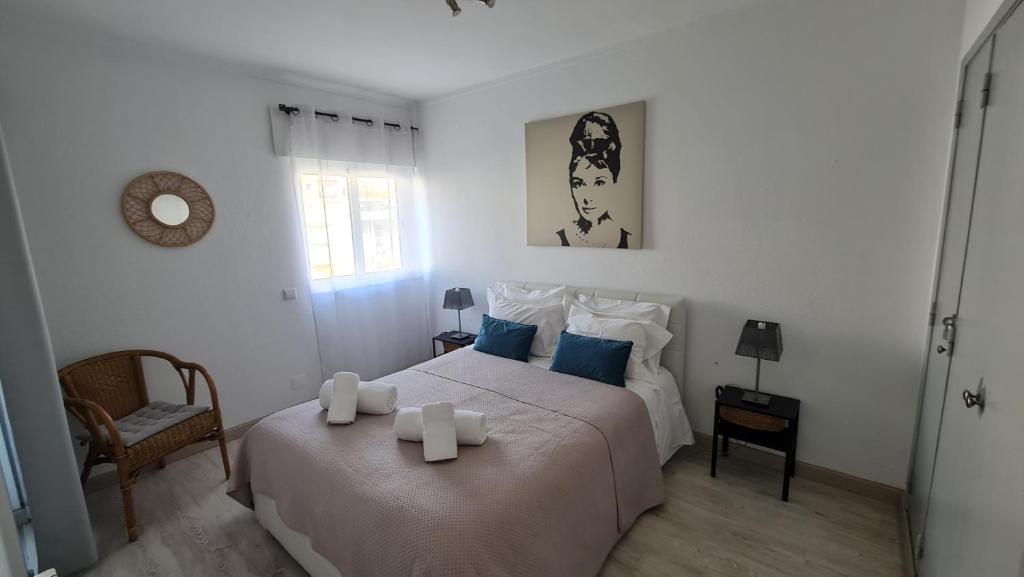 a bedroom with a bed with two candles on it at Apartamento T1 centro Albufeira in Albufeira