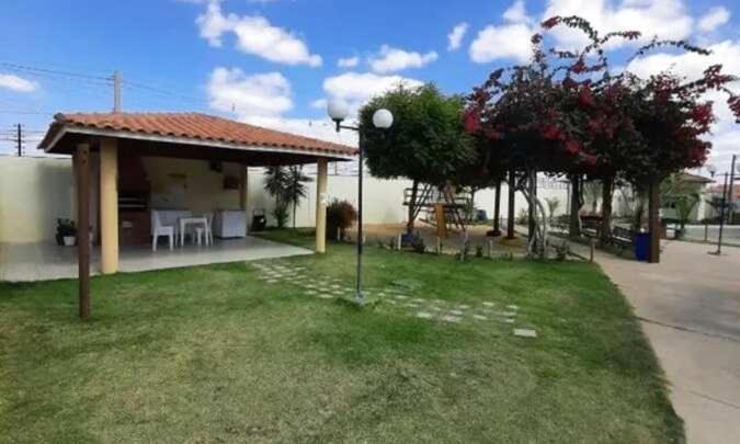 a house with a table and chairs in a yard at Condomínio São Francisco in Petrolina