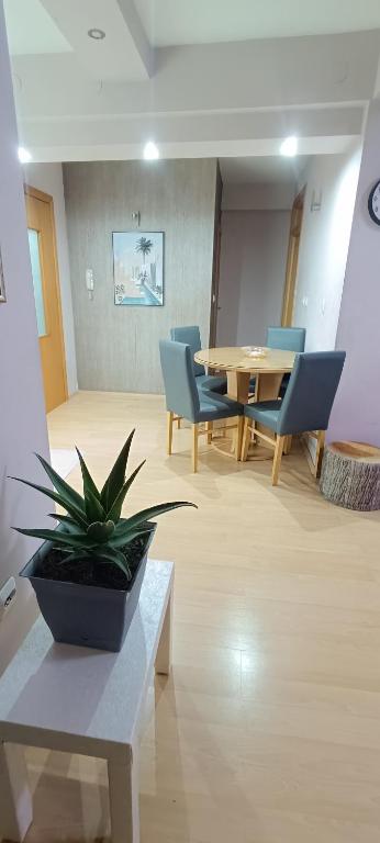 a room with a table and chairs and a potted plant at Ohrid Demarko Apartment in Ohrid