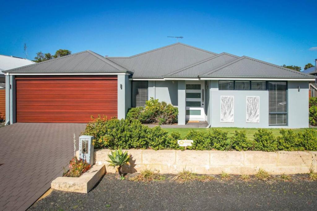 a large house with a red garage at The Monclair Retreat - Pet Friendly Dunsborough in Dunsborough