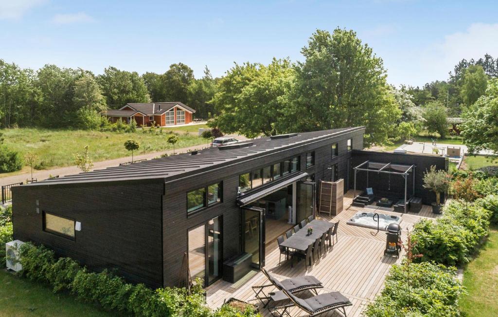 an aerial view of a black house with a deck at Amazing Home In Rødby With Sauna in Rødby