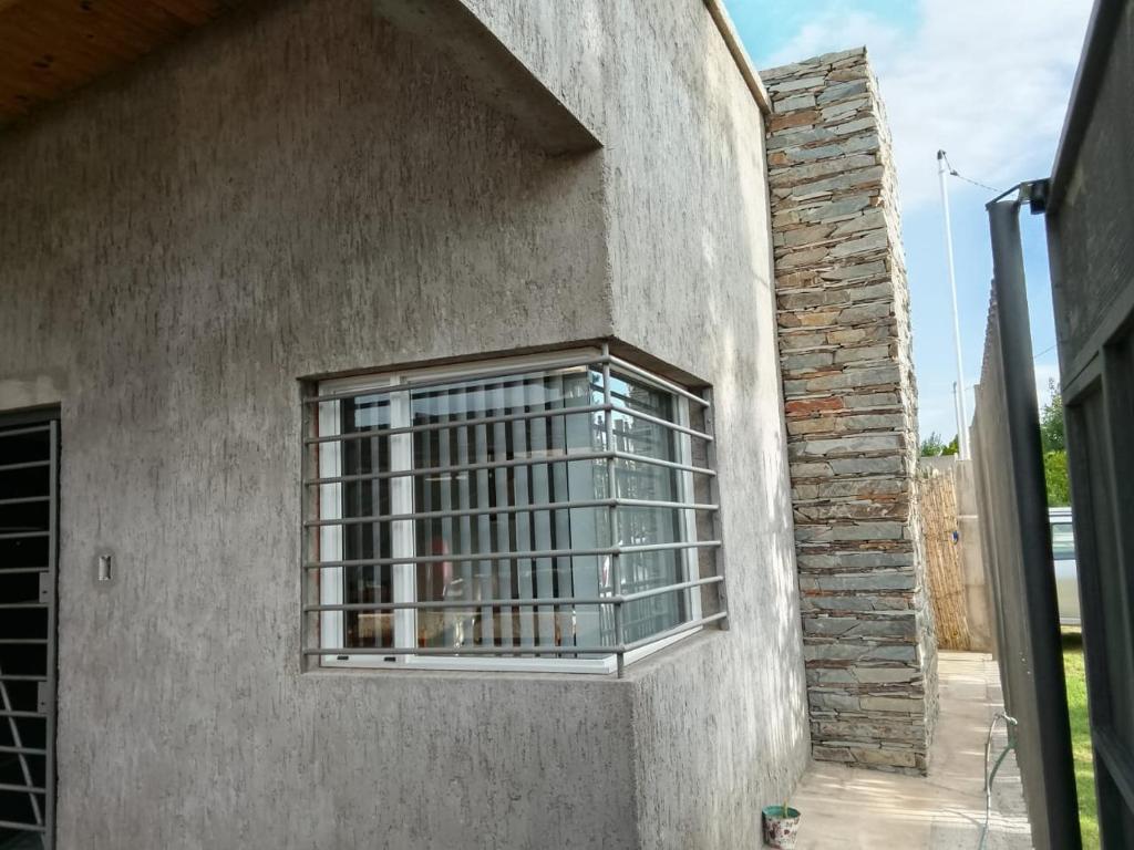 a window with bars on the side of a building at Casa Simón in San Rafael