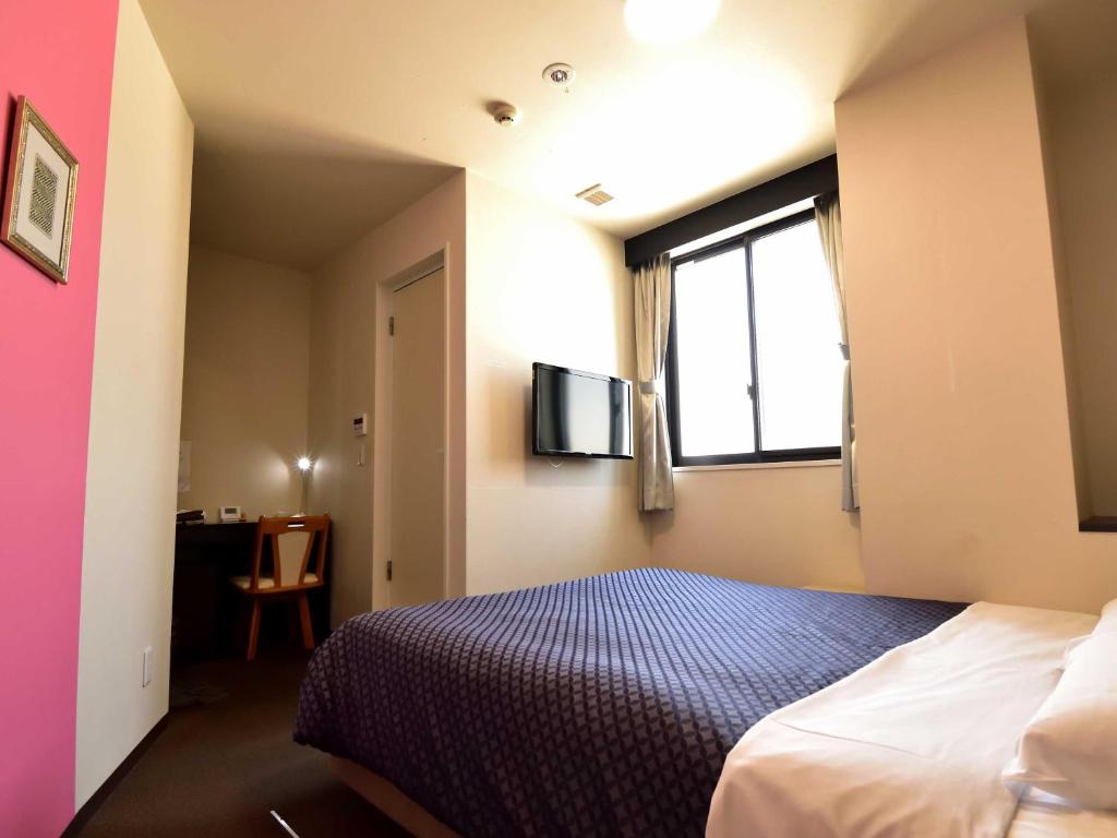 Postel nebo postele na pokoji v ubytování Izutsu Hotel Kyoto Kawaramachi Sanjo