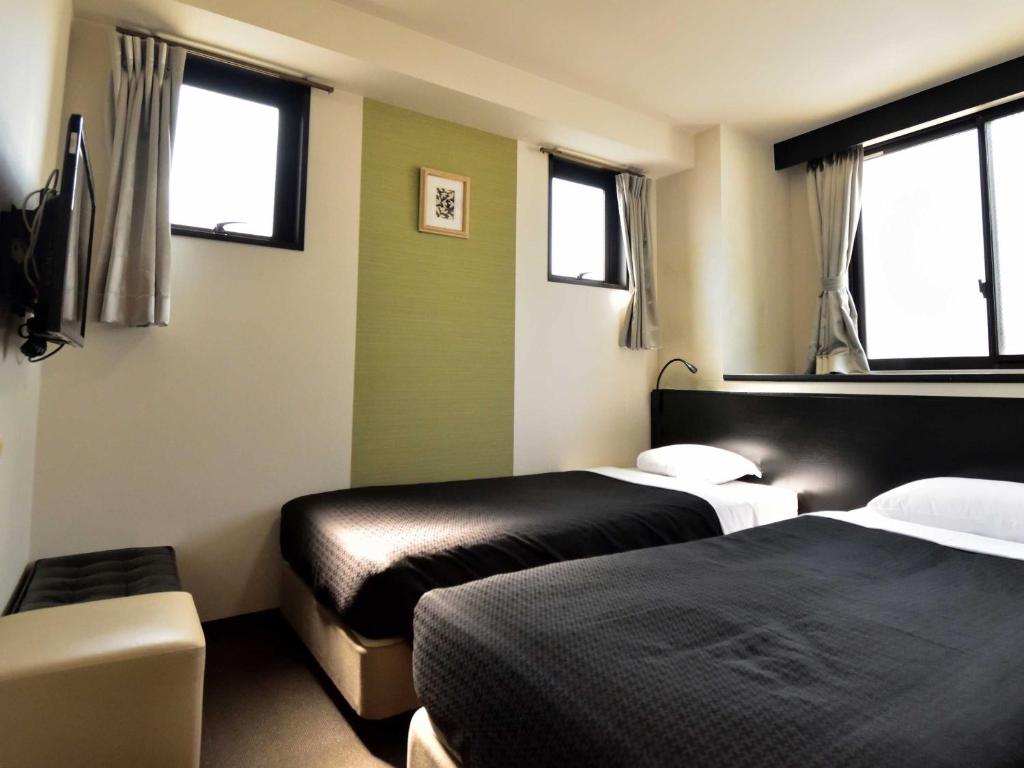 Postel nebo postele na pokoji v ubytování Izutsu Hotel Kyoto Kawaramachi Sanjo