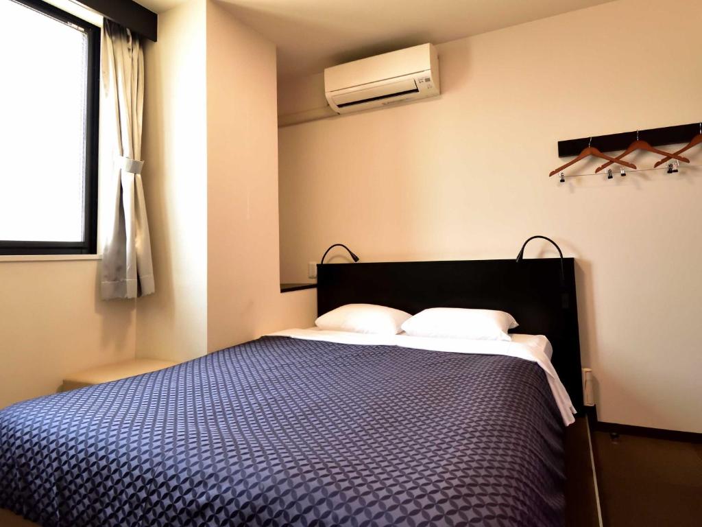 Postel nebo postele na pokoji v ubytování Izutsu Hotel Kyoto Kawaramachi Sanjo
