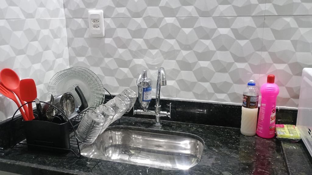a kitchen sink with two faucets on a counter at Hospedagem Cinelândia AP 617 in Rio de Janeiro