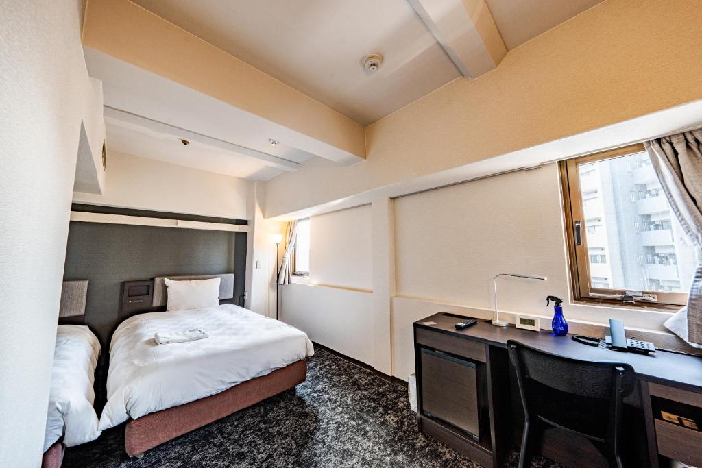 Postel nebo postele na pokoji v ubytování Hotel Consort Shin-Osaka