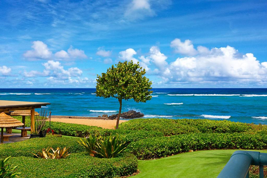 a view of the ocean from a resort with a tree at Waipouli Beach Resort Exquisite Ocean View Condo With Beach Front View! AC Pool in Kapaa