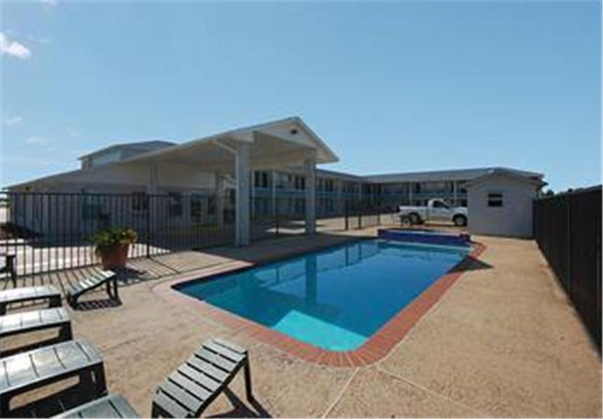 a large swimming pool in front of a house at Summit Inn Hempstead in Hempstead