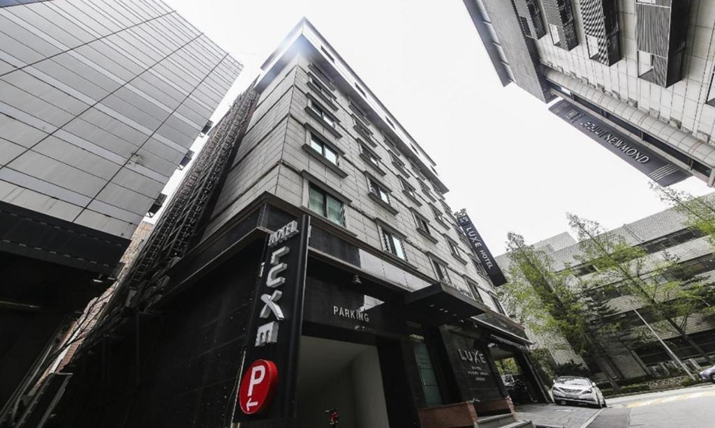 a building with a sign on the front of it at Nowon Luxe Hotel in Seoul